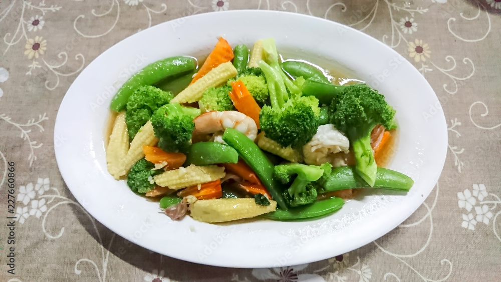 Stir fried broccoli with shrimp on white plate Stir fried broccoli with shrimp on white plate