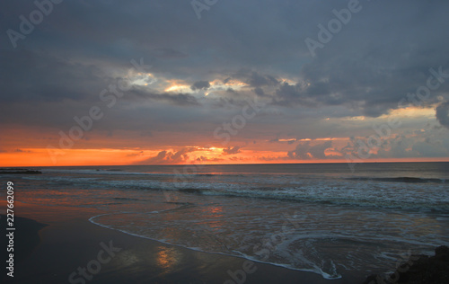 Sunrise on the beach with ocean waves Folly beach South Carolina