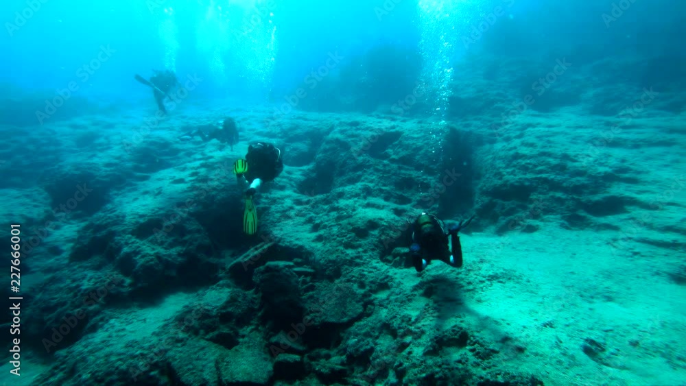 Group of scuba divers swimming over coral reef in Kas, Turkey Group of scuba divers swimming over coral reef in Kas, Turkey