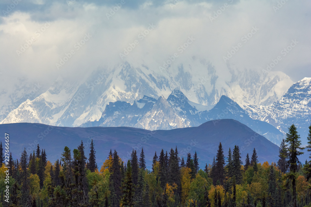 Snowy mountain peaks obscured by clouds