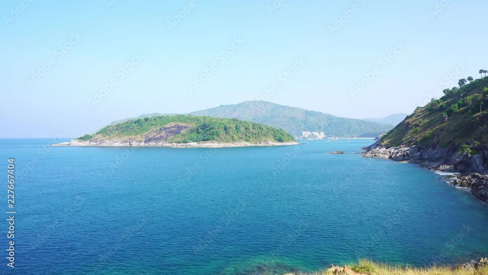 small island in tropical sea against blue sky background small island in tropical sea against blue sky background