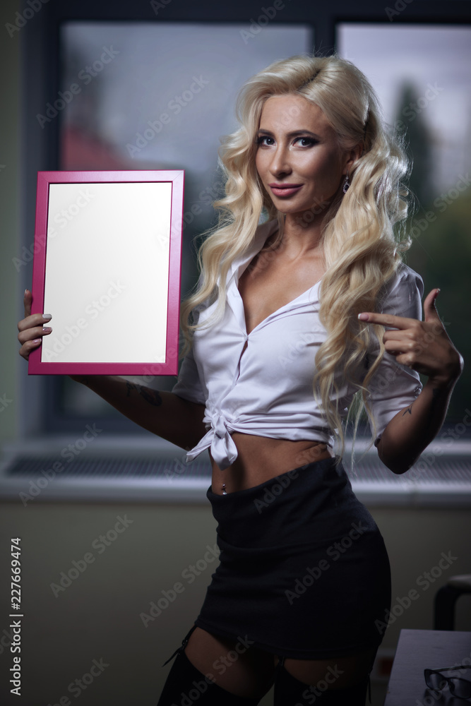 sexy employee in the office posing with a sign in her hands Stock Photo |  Adobe Stock
