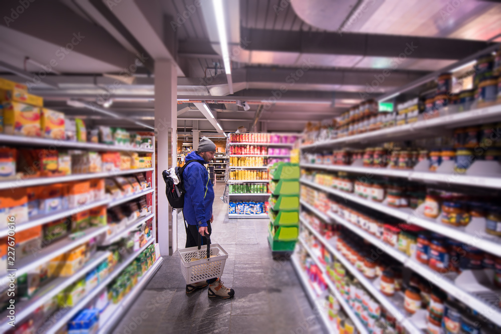 Man shopping in modern supermarket