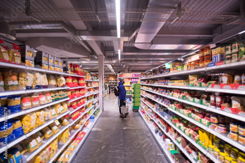 Man shopping in modern supermarket