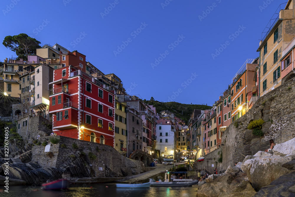The beautiful seaside village of Riomaggiore in the light of the blue hour, Cinque Terre, Liguria, Italy