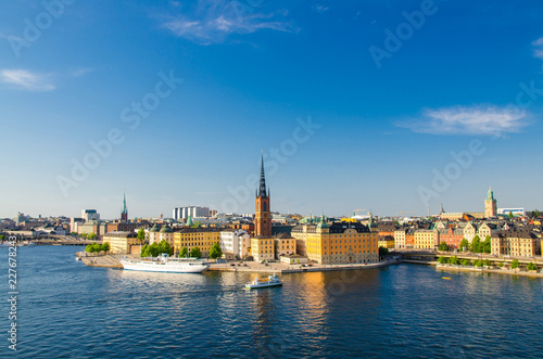 Aerial panoramic top view of Riddarholmen district with Riddarholm Church and typical sweden gothic buildings, boat ship sailing on water of Lake Malaren from Sodermalm island in Stockholm, Sweden photo