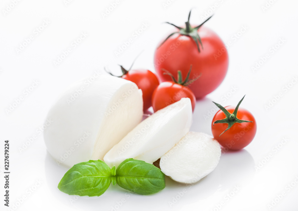 Fresh Mozzarella cheese with tomatoes and basil leaf on white background. Fresh Mozzarella cheese with tomatoes and basil leaf on white background.