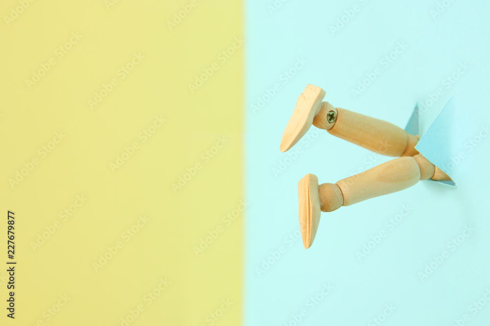 concept image of wooden dummy stuck upside down. stress and danger concept. concept image of wooden dummy stuck upside down. stress and danger concept.