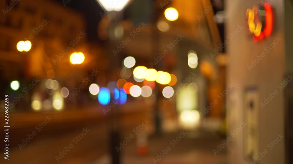 Out of focus background plate of city street from sidewalk at night Out of focus background plate of city street from sidewalk at night