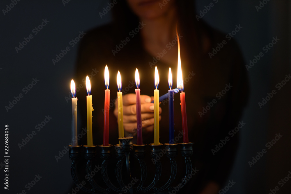 Hanukkah Being a light in the darkness. Jewish Woman lighting Hanukkah
