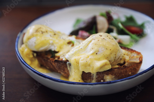 Egg benedict , poached eggs with toast on wood background , English Breakfast