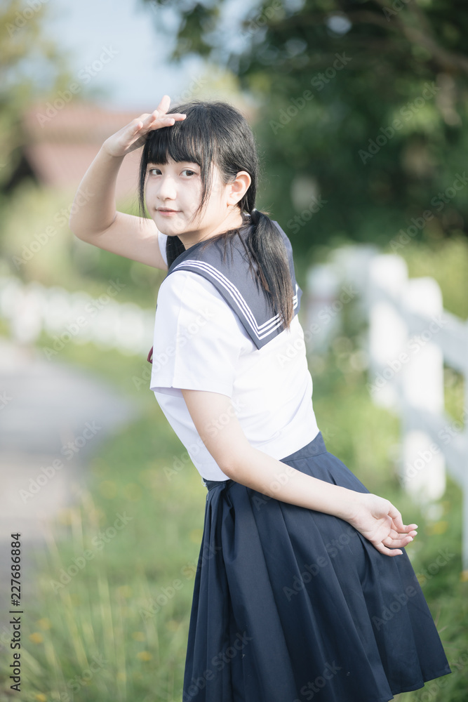 Portrait of asian japanese school girl costume looking at park outdoor film vintage style Portrait of asian japanese school girl costume looking at park outdoor film vintage style