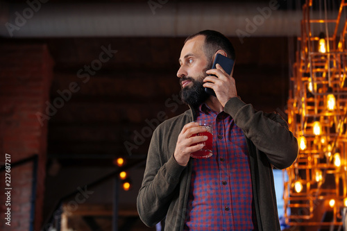 businessman male brunette beard glass hold cafe office house loft brave bearded hipster mulled wine