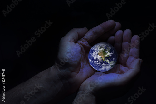 Fototapeta Naklejka Na Ścianę i Meble -  Two hands protect the earth globe. Elements of this image furnished by NASA.