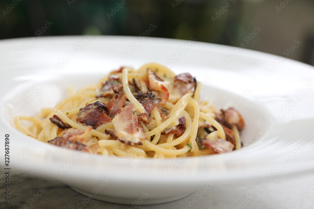 Spaghetti carbonara , Spaghetti white sauce with cheese bacon in outdoor restaurant italian food