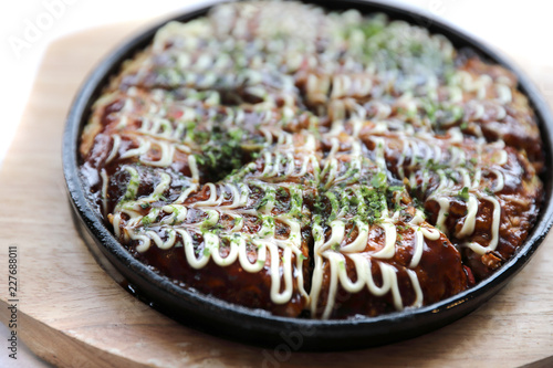 Japanese food okonomiyaki , Japanese pizza on wood plate photo