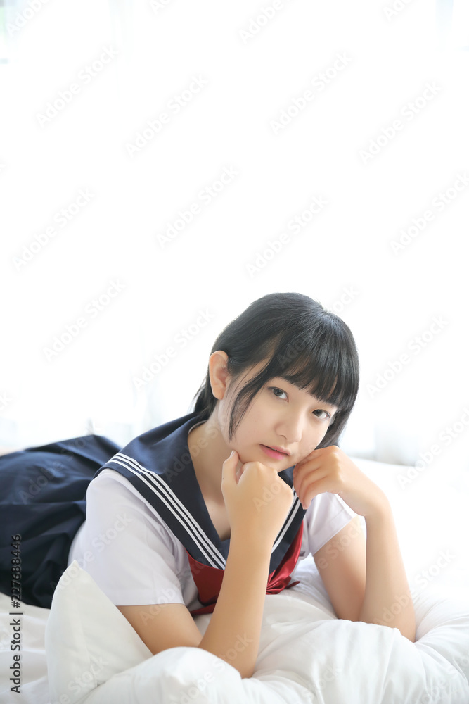 Portrait japanese school girl in white tone bed room Portrait japanese school girl in white tone bed room
