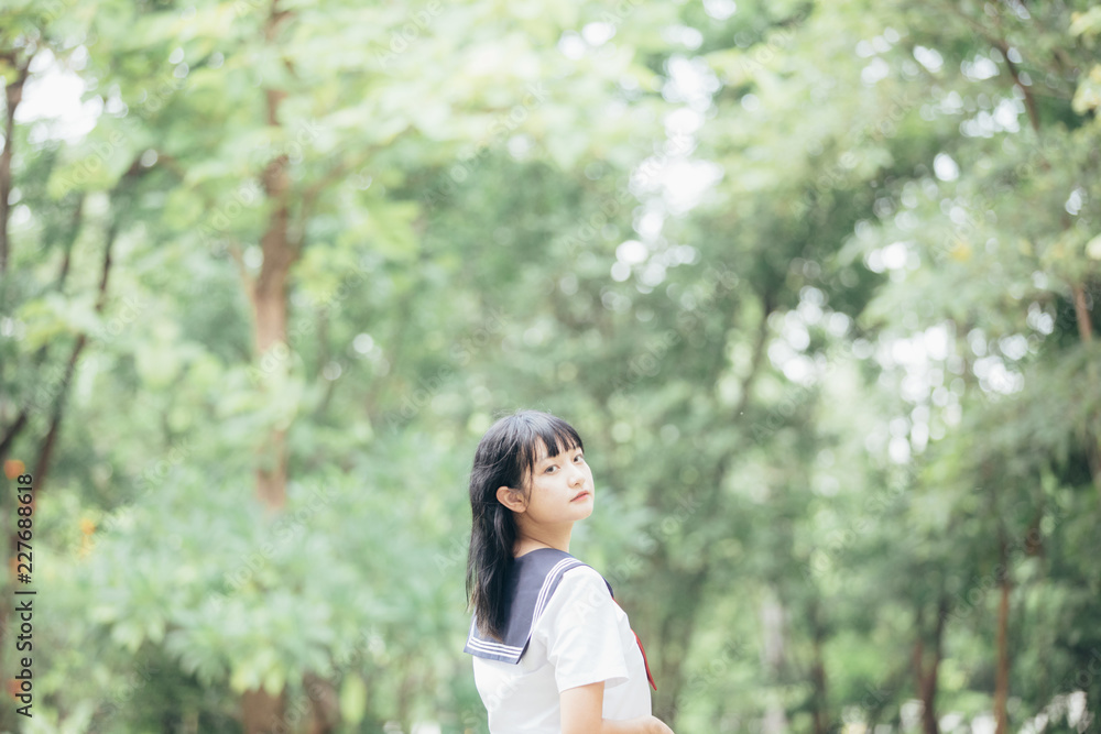 Portrait of asian japanese school girl costume looking at park outdoor film vintage style Portrait of asian japanese school girl costume looking at park outdoor film vintage style