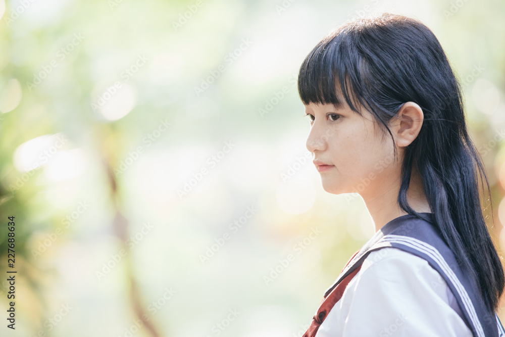 Portrait of asian japanese school girl costume looking at park outdoor film vintage style Portrait of asian japanese school girl costume looking at park outdoor film vintage style