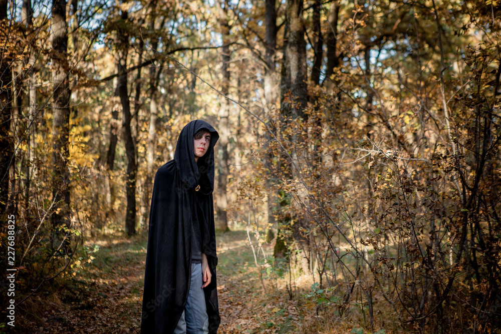 Teenagers in Halloween costumes in the woods. Halloween vampire in the woods Teenagers in Halloween costumes in the woods. Halloween vampire in the woods