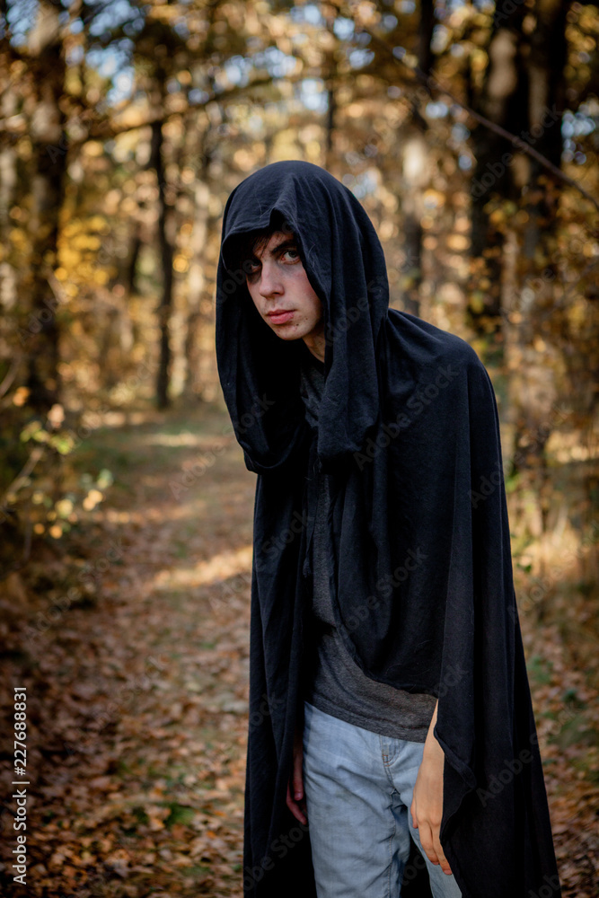 Teenagers in Halloween costumes in the woods. Halloween vampire in the woods Teenagers in Halloween costumes in the woods. Halloween vampire in the woods