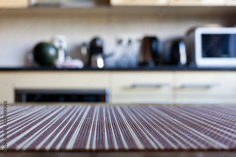 blurred kitchen interior - focus on napkin and desk space blurred kitchen interior - focus on napkin and desk space