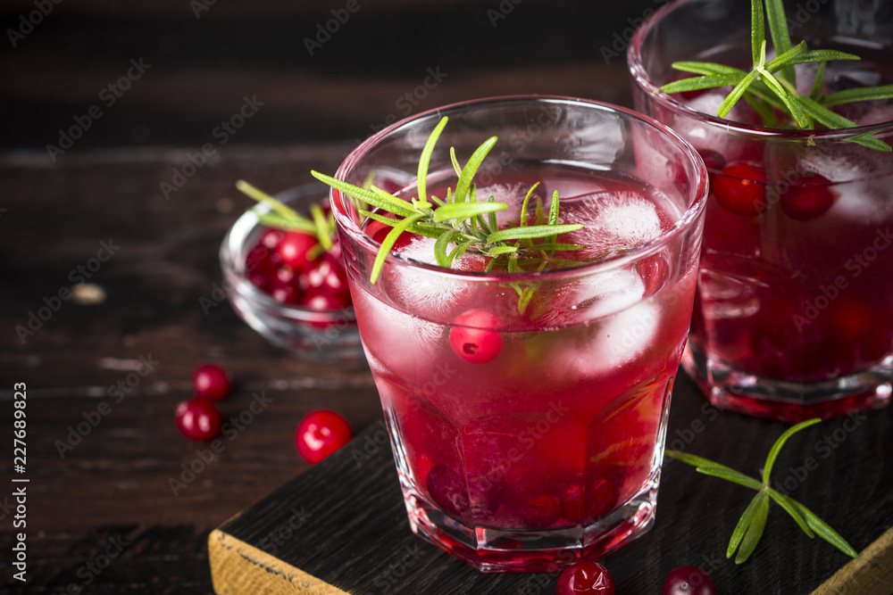 Cocktail with cranberry, vodka, rosemary and ice. Cocktail with cranberry, vodka, rosemary and ice.