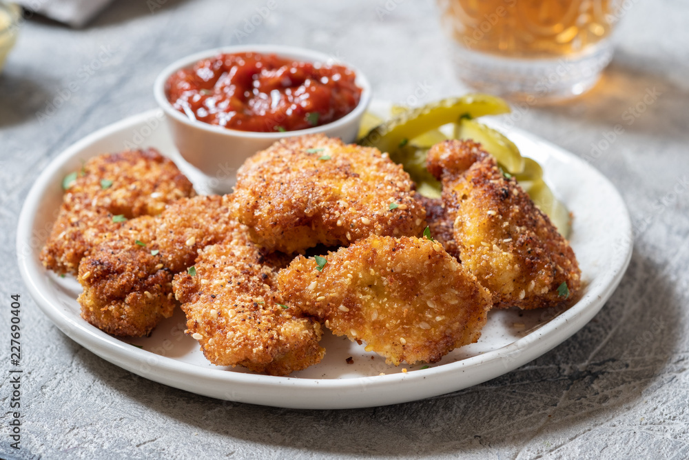Fried crispy chicken nuggets with ketchup and pickles Fried crispy chicken nuggets with ketchup and pickles