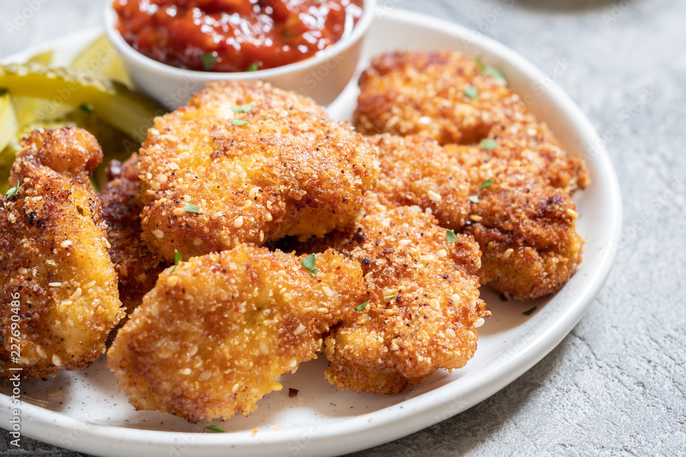 Fried crispy chicken nuggets with ketchup and pickles Fried crispy chicken nuggets with ketchup and pickles