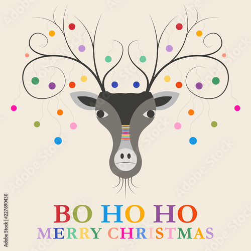 colourful Christmas reindeer with baubles hanging from his antlers and a  yarn-bombed nose