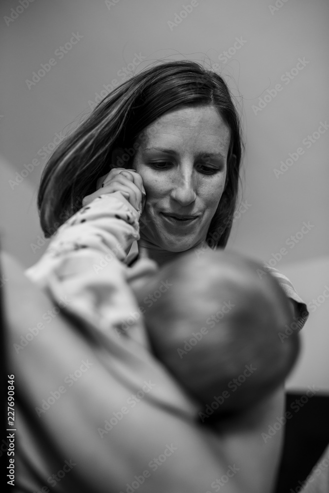 Young mother lovingly cuddling her baby Young mother lovingly cuddling her baby