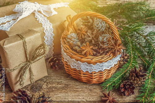 Christmas New Year composition with gift box fir branch basket pine cones on old shabby rustic wooden background. Xmas holiday december decoration to Russian tradition. Flat lay  copy space