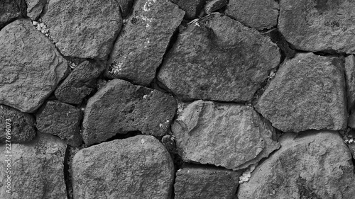 Black and white background wich basalt stone wall