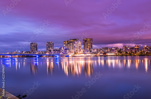 Modern apartments in a medium density suburb along the river. Reflections in the water. Dusk sky. Long exposure