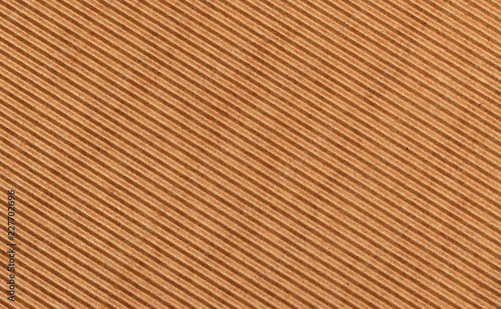 Texture of waved brown craft cardboard Texture of waved brown craft cardboard