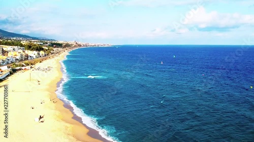 Montgat beach with windsurf and kitesurf gliding in a sunny day photo