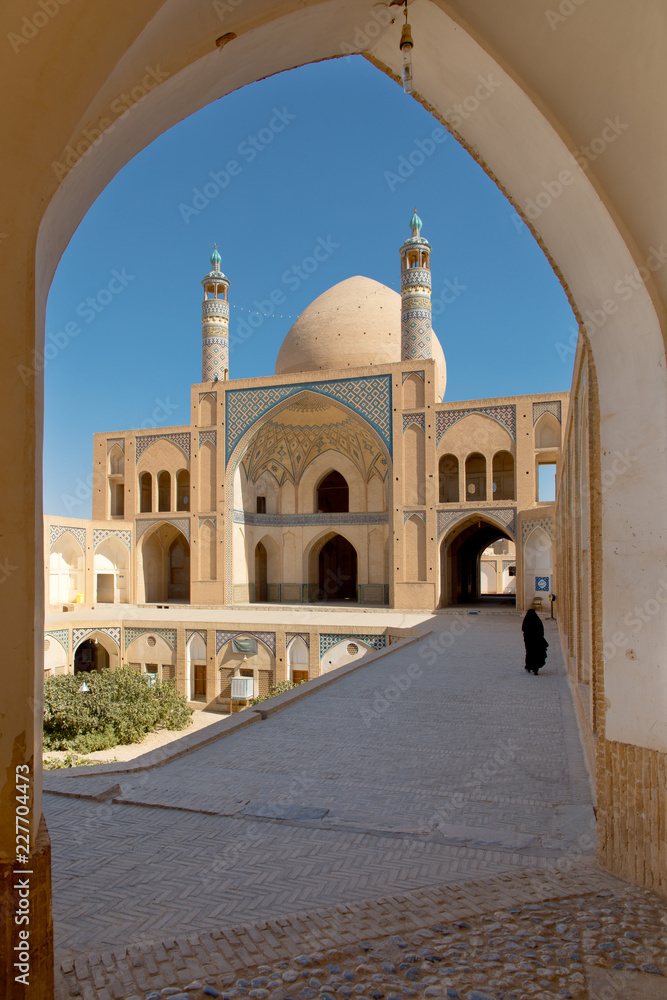 Fototapeta premium Muslim woman walking in Iran at Kashan Mosque
