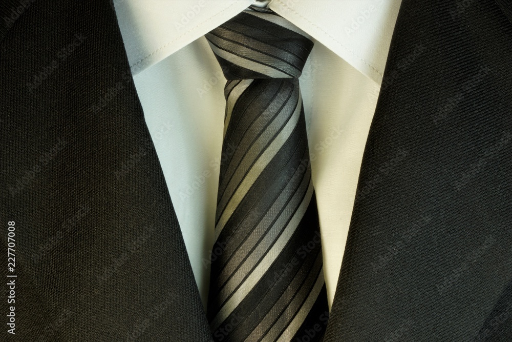 Tie and white shirt and suit, in the wardrobe of men used as decoration, accessory, part of business clothing. Wear to a wedding, prom or graduation. Tie and white shirt and suit, in the wardrobe of men used as decoration, accessory, part of business clothing. Wear to a wedding, prom or graduation.
