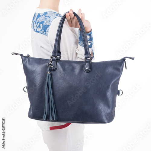  woman with blue handbag in hands. Isolated white background.