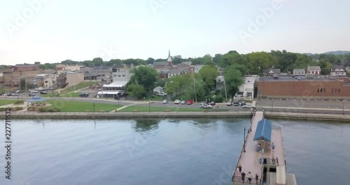 Aerial drone shot over the city buildings and churches out to the waters edge with a pier in Keyport, New Jersey. photo