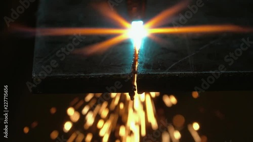 Oxyacetylene cutting through steel, torch burning and sparks flying