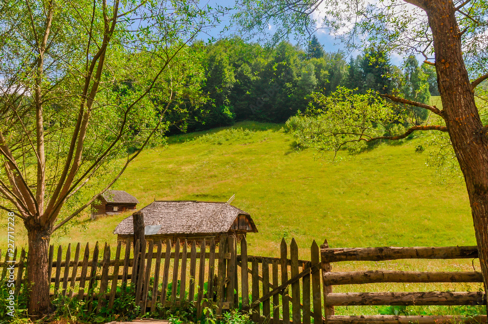 Small rural huts in the middle of green meadows in the mountains of Romania. Small rural huts in the middle of green meadows in the mountains of Romania.
