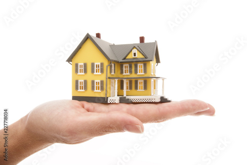 house in human hands isolated on white