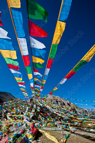 Tibetan prayer flags on blue sky photo