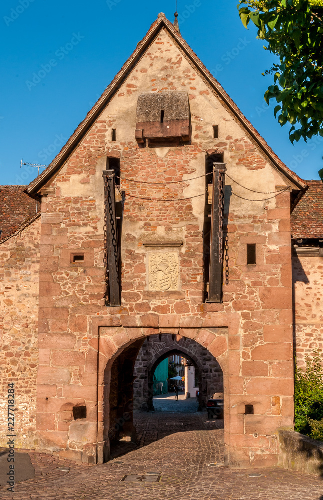 Riquewehr medieval city gate with draw bridge in Alsace France Riquewehr medieval city gate with draw bridge in Alsace France