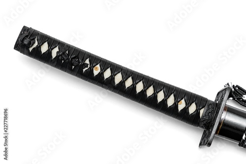 Tsuka handle of Japanese sword  isolated in white background. White rayskin and black leather cord. photo