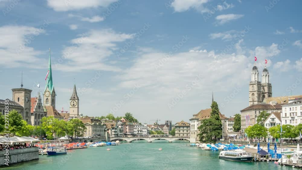 Zurich, old historic town panorama with the Munsterbrucke stone bridge over the river Limmat, connecting two famous buildings, the Grossmunster and the Fraumunster Church.