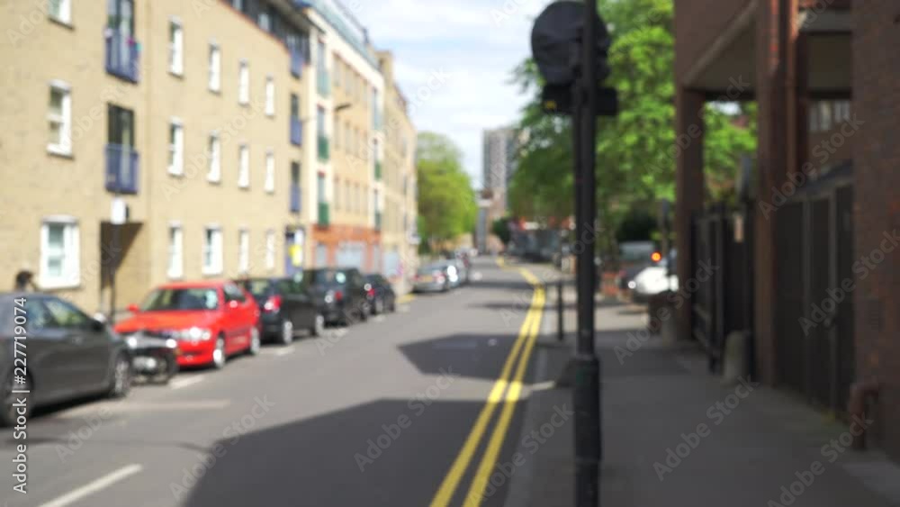 Defocused shot of short residential buildings along London street Defocused shot of short residential buildings along London street