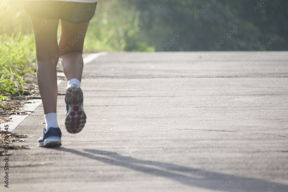 Runner woman running on the Concrete road morning with nature of mountain and tree. Runner woman running on the Concrete road morning with nature of mountain and tree.