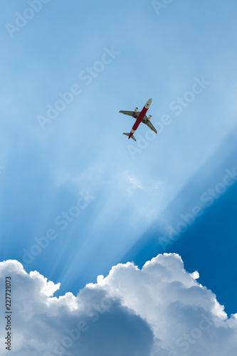 A worm's-eye view of an airplane on sky with sunlight
